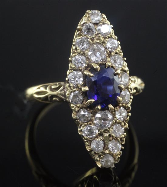 An 18ct gold marquise shaped sapphire and diamond dress ring, size N.
